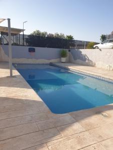 a swimming pool with blue water in a yard at Casa de la Vida Liebetruth A in Aspe