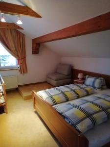 a bedroom with two beds and a couch in it at Pension Strauss in Sankt Lorenzen ob Murau