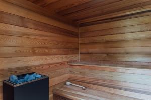 a wooden sauna with a black box in the corner at Beautiful Countryside Farmhouse in Sutton Bonington