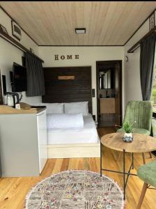 a bedroom with a bed and a table and chairs at Danzi camping tiny house in Rize
