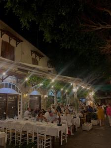 a group of people sitting at tables at night at The Knights Courtyard in Rhodes Town