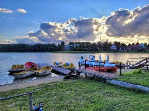 un groupe de bateaux garés à un quai sur un lac dans l'établissement Domek nad morzem Wisełka, à Wisełka