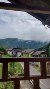 a view of a town from a wooden balcony at Apartman Mely in Kulen Vakuf