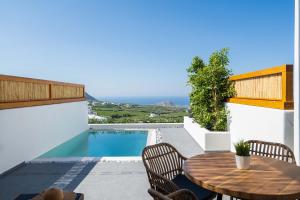 a patio with a table and chairs and a pool at La Torretta in Pyrgos