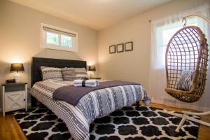 a bedroom with a bed and a wicker chair at Four Bedroom house by MSP & MOA! in Richfield