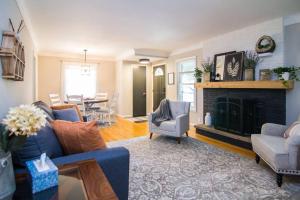 a living room with a blue couch and a fireplace at Four Bedroom house by MSP & MOA! in Richfield