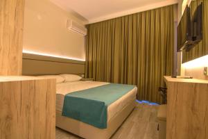 Postel nebo postele na pokoji v ubytování Palmea Hotel