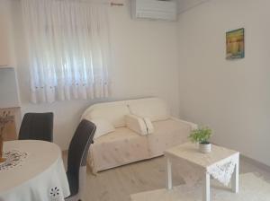 a living room with a couch and a table at Apartman Mimi in Matulji