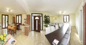 a dining room with a long table and white chairs at Borgo Dei Sensi in Casumaro