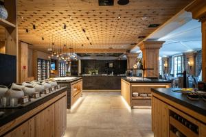 a large kitchen with wooden cabinets and a large island at Alpenhotel Ischglerhof in Ischgl