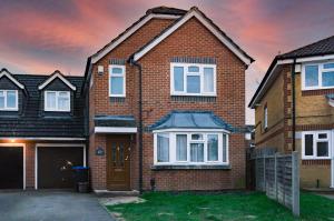 a brick house with a driveway in front of it at Burnham House - LABRAD HOMES in Burnham