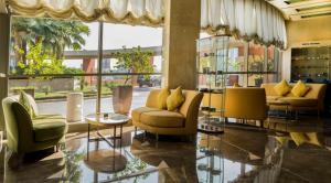 a lobby with couches and chairs in a building at Marina Hotel in Kuwait