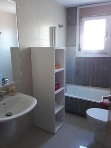 a bathroom with a sink and a toilet and a tub at A RIA DE PONTEVEDRA in Pontevedra