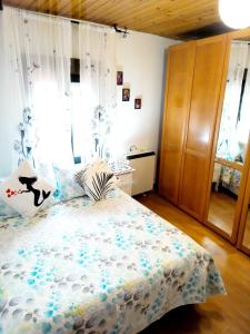a bedroom with a bed and a wooden cabinet at HABITACIONES PRIVADAS - CASA RURAL - Baño compartido con los anfitriones in Suances