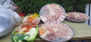 four bowls of food sitting on a wooden table at Yafin khaokho Camping in Ban Pa Daeng