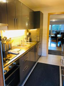 a kitchen with a sink and a counter top at Appartement traversant secteur Violettes in Crans-Montana