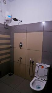 a bathroom with a toilet and a shower stall at WAYANAD OASIS VILLa in Kalpetta