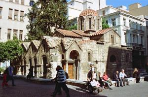 a group of people walking in front of a church at Diana's Suite viewing the Acropolis in Athens