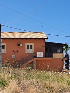 a house with a fence in front of it at La Foggia seaside paradise in Siculiana