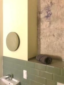 a bathroom with a sink and a mirror and a towel at Bahnhof Nebra in Nebra