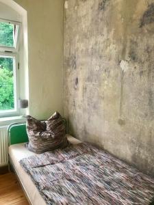 a room with a bed with a pillow on it at Bahnhof Nebra in Nebra