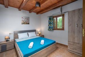 a bedroom with a large blue bed with a window at Etia - Venetian Villa 