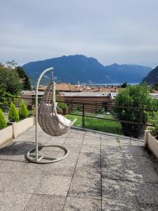 a metal sculpture of a hammock on a sidewalk at appartamento PEACE&LAKE in Riva del Garda