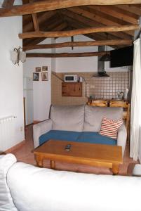 a living room with a couch and a coffee table at Casas Rurales Los Cortijos in Alcaraz