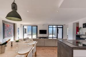a living room with a table and a couch at Villa Bamboo in Lathuile
