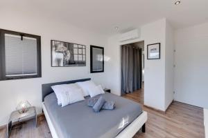 a white bedroom with a large bed with two pillows at Villa Bamboo in Lathuile +35 photos