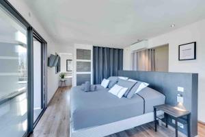 a bedroom with a large blue bed and a window at Villa Bamboo in Lathuile +55 photos
