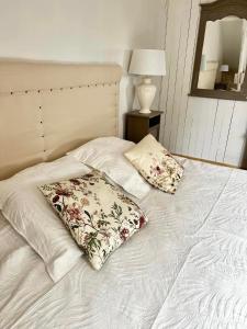 a white bed with two pillows on top of it at Chambre duo in Sainte-Gemme-la-Plaine