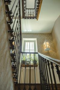 a staircase with black railings and a window at Chambre duo in Sainte-Gemme-la-Plaine