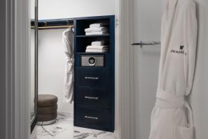 a bathroom with a black dresser with a towel at JW Marriott Savannah Plant Riverside District in Savannah