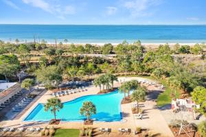 an aerial view of a resort with a pool and the ocean at Beach Haven at WindMark by Pristine Properties Vacation Rentals in Highland View +97 photos