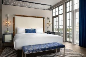 a bedroom with a large bed and a large window at JW Marriott Savannah Plant Riverside District in Savannah