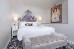 a bedroom with a large white bed and a chair at JW Marriott Savannah Plant Riverside District in Savannah