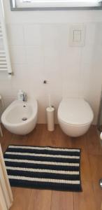 a bathroom with a white toilet and a sink at Eolia free parking in Bari