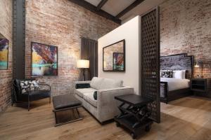 a living room with a couch and a bed at JW Marriott Savannah Plant Riverside District in Savannah