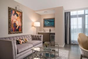 a living room with a couch and a table at JW Marriott Savannah Plant Riverside District in Savannah