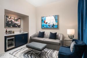 a living room with a couch and a chair at JW Marriott Savannah Plant Riverside District in Savannah