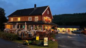 a large building with tables and chairs in front of it at Gullvåg Camping Nyberg in Soknedal