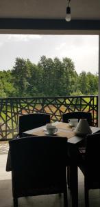 a wooden table with bowls and plates on top of it at Luxury Villa Četiri Hrasta Apartment in Pićan