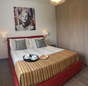 a bed with a tray of food on top of it at Luxury Villa Četiri Hrasta Apartment in Pićan