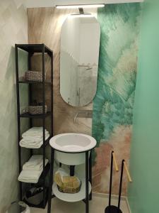 a bathroom with a sink and a mirror at Dimore Gilas - Suite Golden in Monopoli