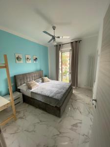 a bedroom with a bed and a ceiling fan at G&A - Apartment in La Spezia