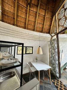 a kitchen and dining room with a table and a sink at Hakunamatata Lodge & Health Spa in Muldersdrift