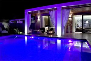 a house with a swimming pool at night at Pelagos Suites Hotel & Spa in Kos