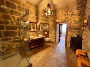 a bathroom with a glass shower and a sink at Commanderie Templière de Cazouls d'Hérault in Cazouls-d Herault +23 photos