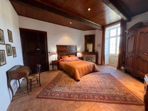 a bedroom with a bed and a large rug at Commanderie Templière de Cazouls d'Hérault in Cazouls-d Herault